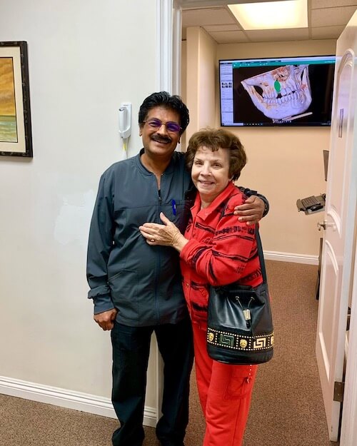 Dr. Narkhede smiling with patient after giving her a dental crown