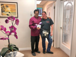Dr. Narkhede smiling with patient who just received dental veneers