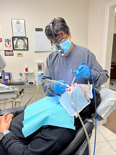 Dr. Pankaj Narkhede working on a patient in the dental chair