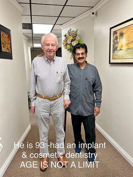 Dr. Narkhede smiling with a patient who just received a smile makeover at his office in Lake Forest, CA